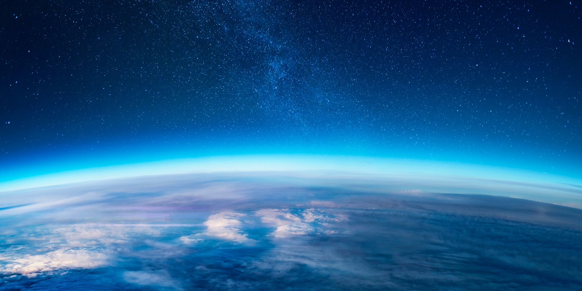 Solavita view of Earth from space with glowing atmosphere and starry night sky