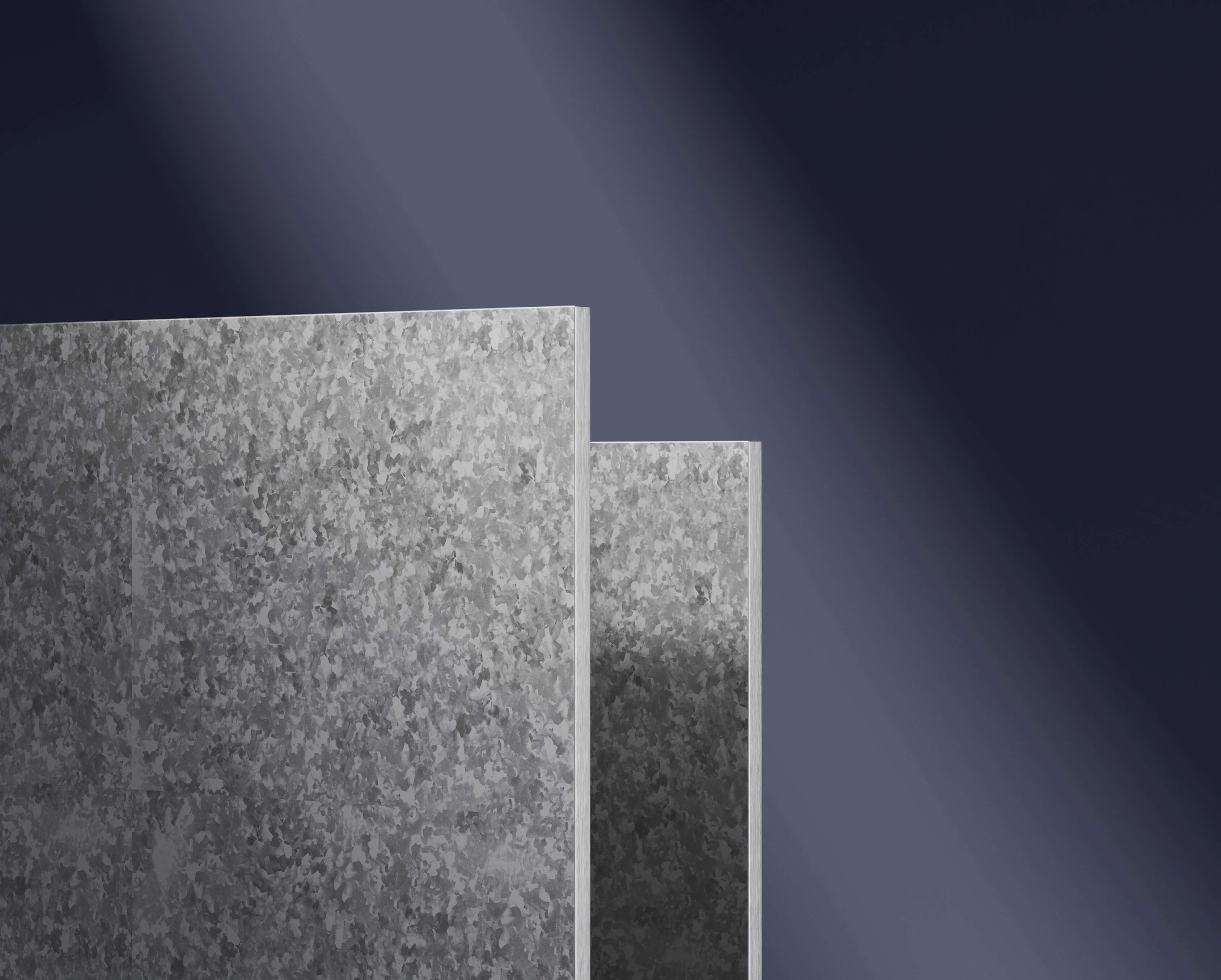 Using mica insulation board.jpgGalvanized steel sheets with textured surfaces, showcasing durability and strength, against a dark background with subtle lighting highlighting the metallic finish