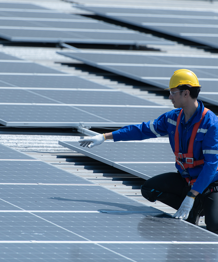 Solavita technician inspecting solar panels during EPC installation on rooftop
