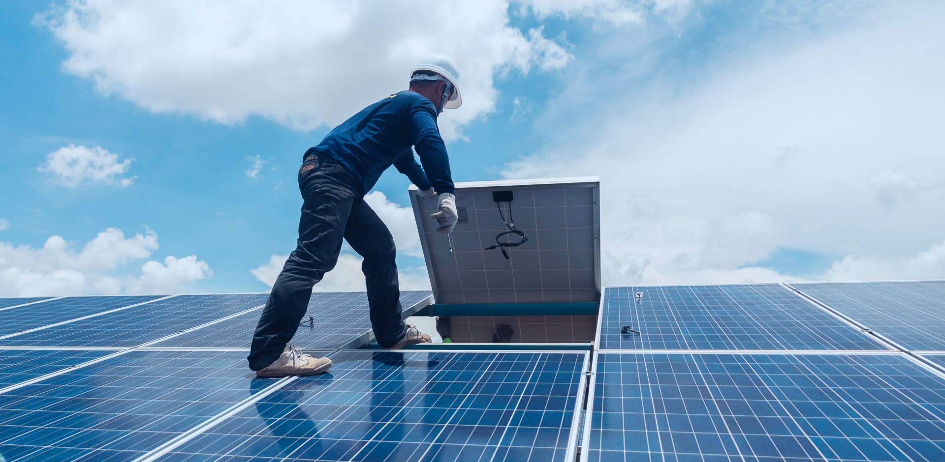 Solavita Residential rooftop with evenly aligned solar panels under a clear blue sky.